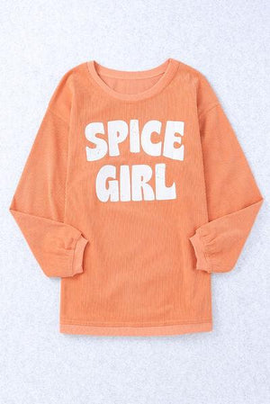 a little girl wearing an orange shirt that says spice girl