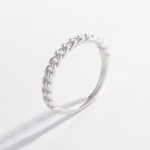 a close up of a silver ring on a white background