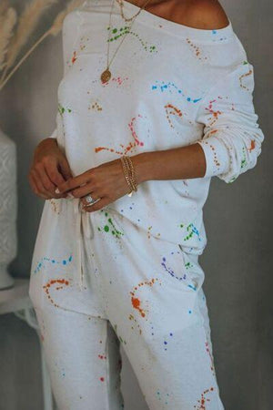 a woman wearing white paint splattered pajamas
