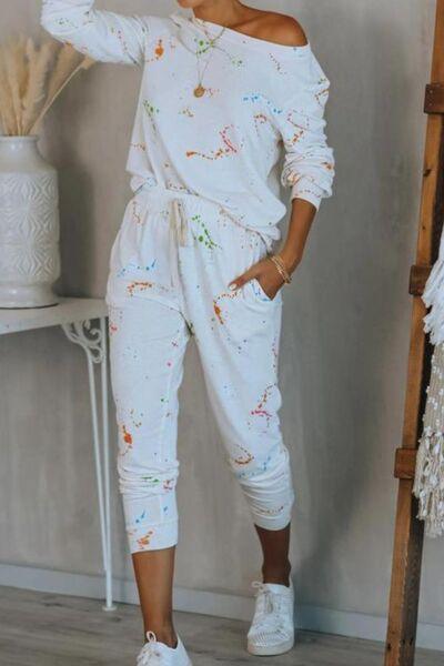 a woman wearing white paint splattered jumpsuits