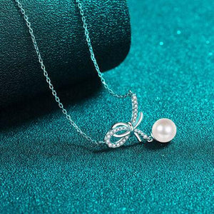 a necklace with a pearl on a chain