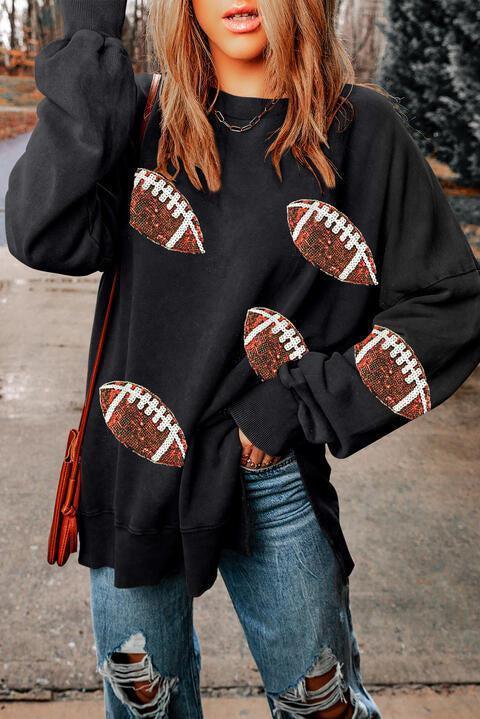 a woman wearing a black sweatshirt with footballs on it