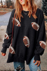 a woman wearing a black sweatshirt with footballs on it