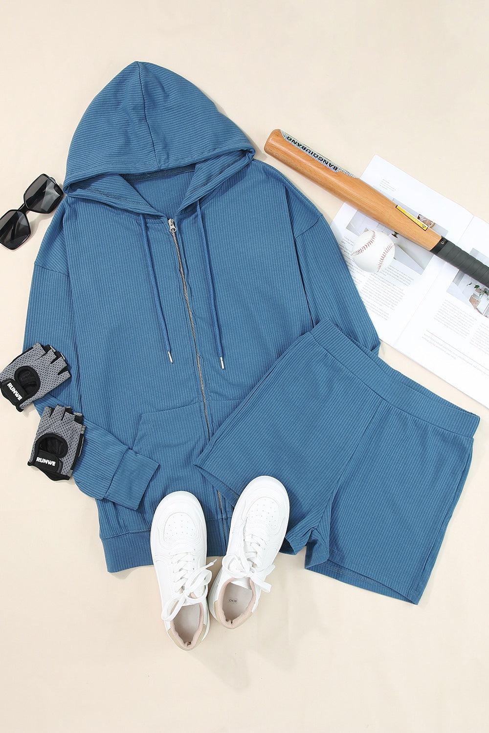 a pair of white tennis shoes and a blue hoodie