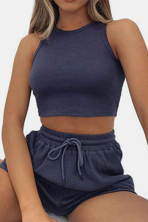 a woman wearing a crop top and shorts