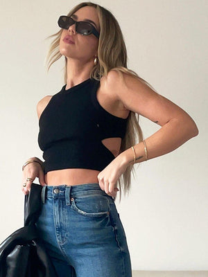 a woman wearing a black top and jeans