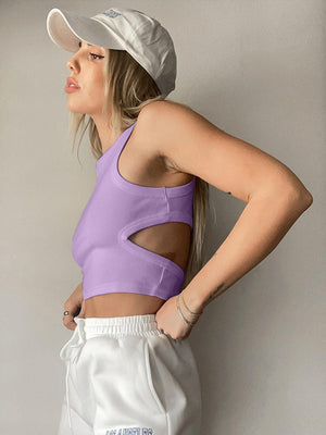 a woman wearing a purple top and white shorts