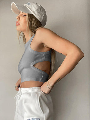 a woman wearing a white hat and a gray sports bra