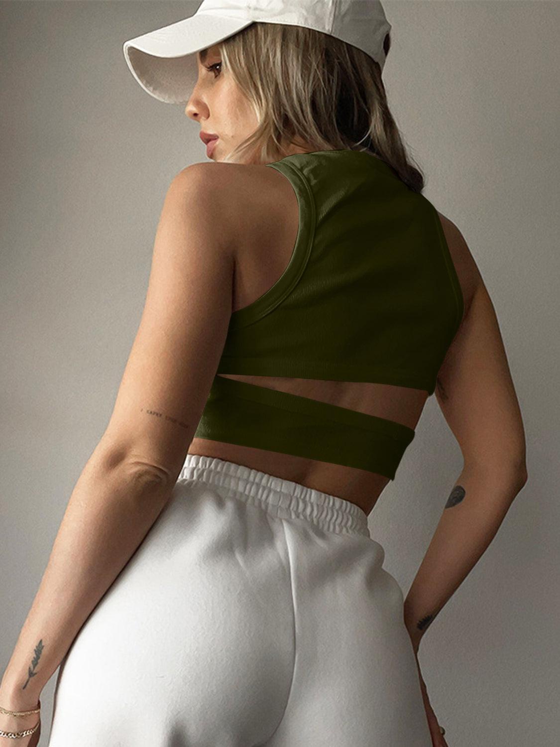 a woman in a green top and white pants