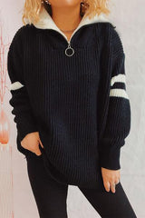 a woman wearing a black sweater with white stripes