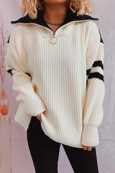 a woman wearing a white sweater and black pants