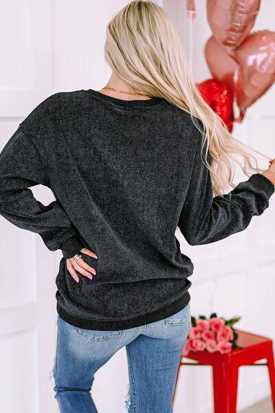 a woman wearing a black sweater and jeans