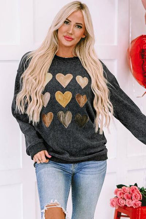 a woman wearing a sweater with hearts on it