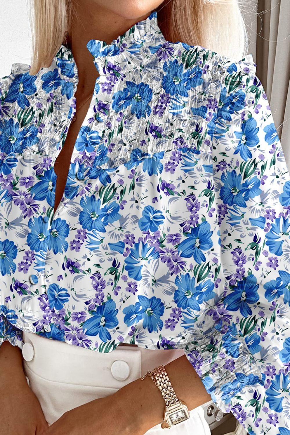 a woman wearing a blue and white floral shirt