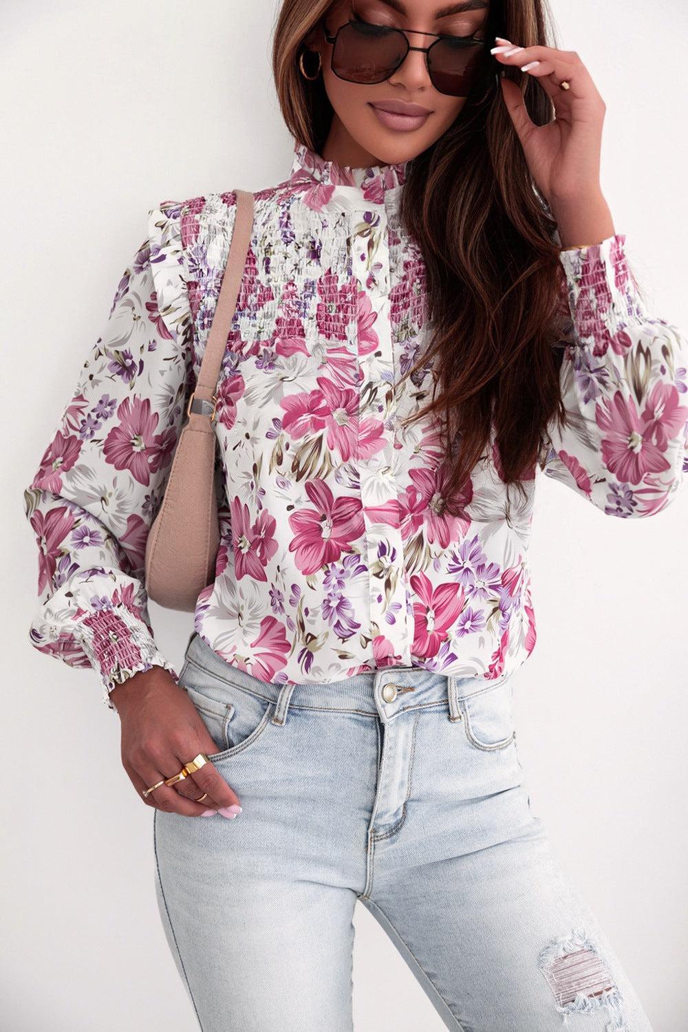 a woman wearing a floral shirt and jeans