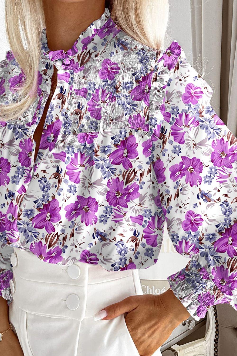 a woman wearing a purple and white floral blouse