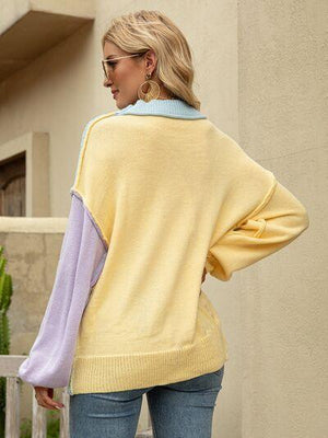 a woman wearing a yellow and purple sweater