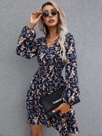 a woman wearing a blue floral print dress