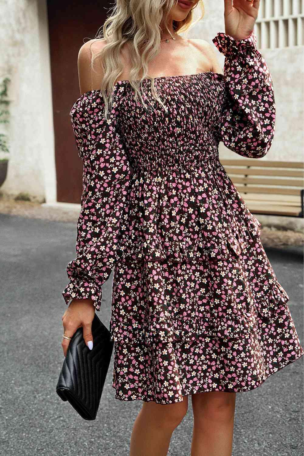 a woman in a black and pink floral print dress