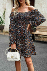 a woman in a floral dress holding a white purse