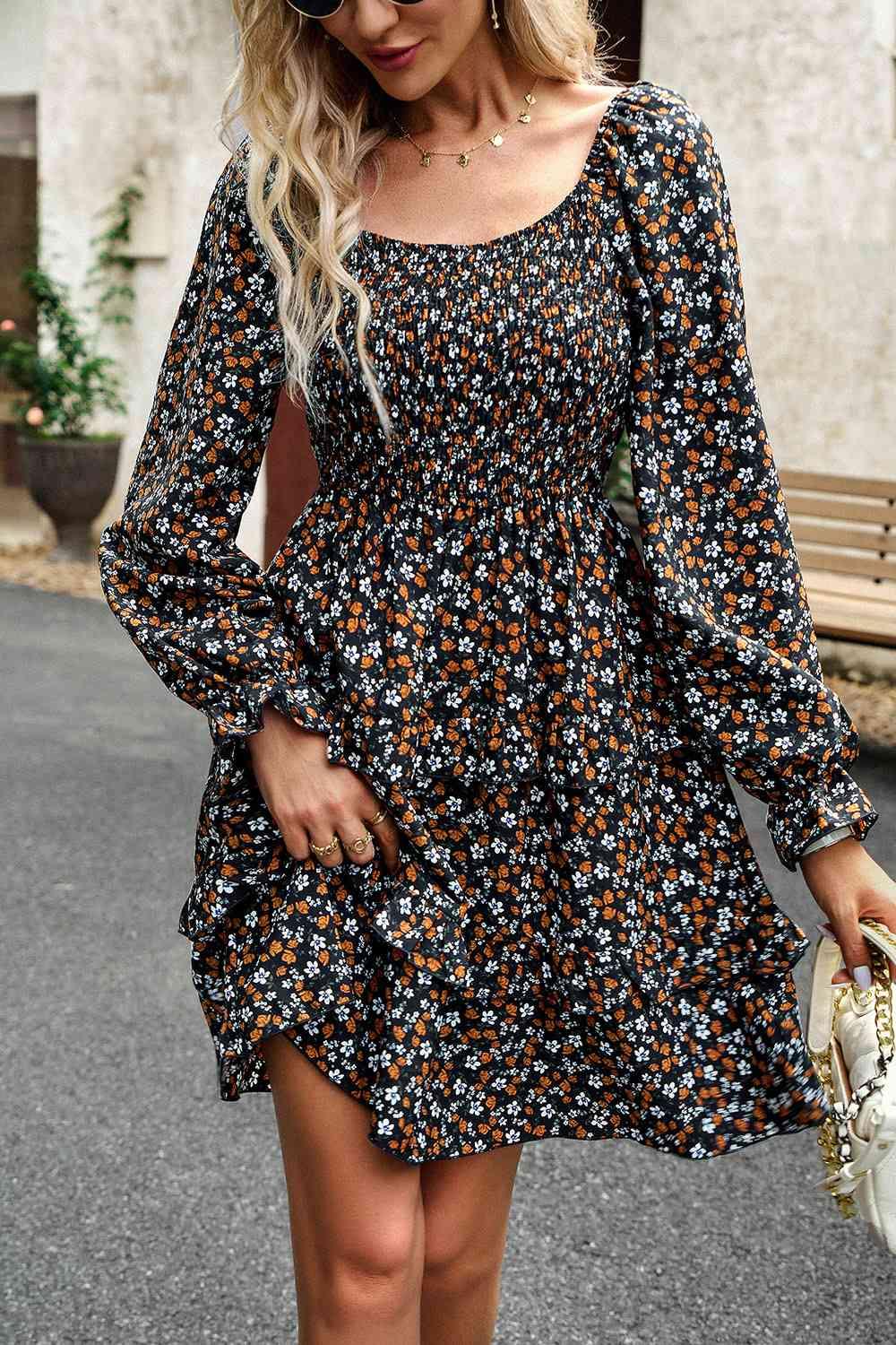 a woman wearing a black floral print dress