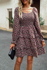 a woman wearing a black and pink floral dress