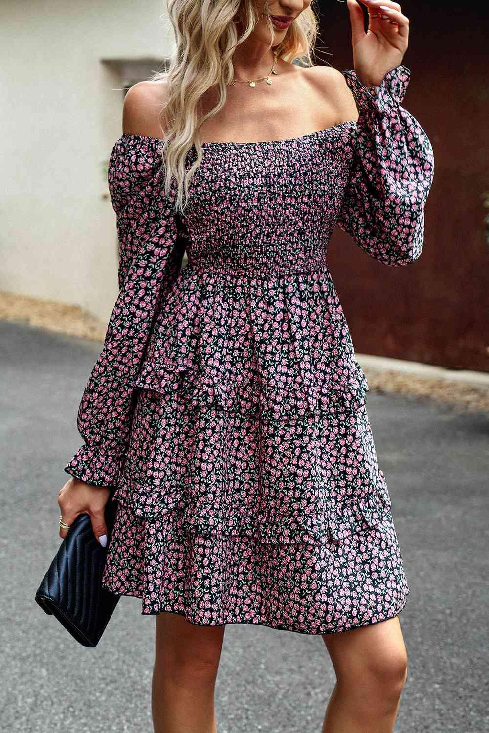 a woman in a floral dress is walking down the street