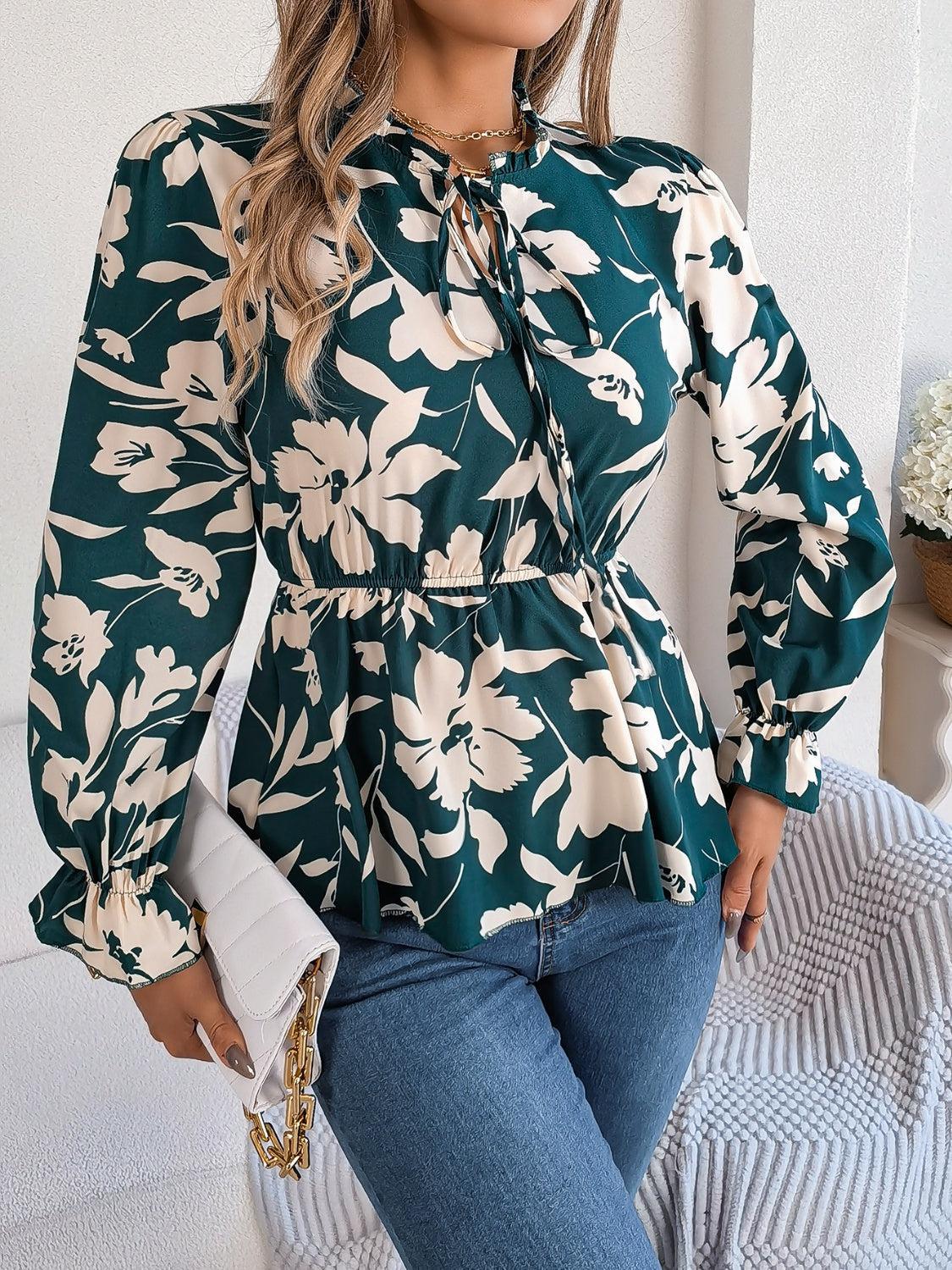 a woman wearing a green floral blouse and jeans