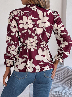 a woman in jeans and a top with flowers on it