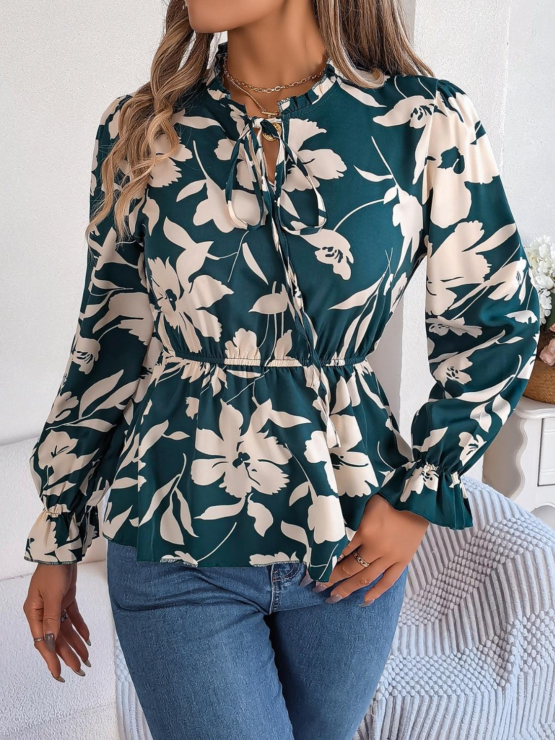 a woman wearing a green and white floral blouse