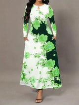a woman wearing a green and white floral print dress