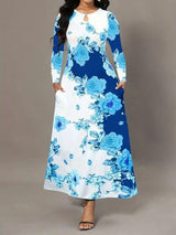 a woman wearing a blue and white floral print dress