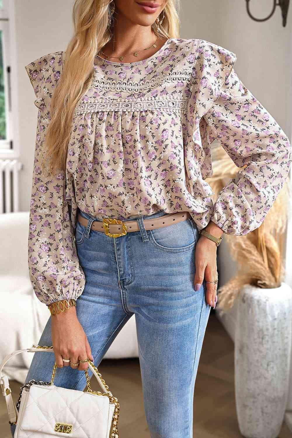 a woman wearing a floral blouse and jeans