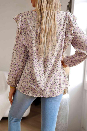 the back of a woman wearing a floral blouse