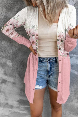 a woman wearing shorts and a pink cardigan