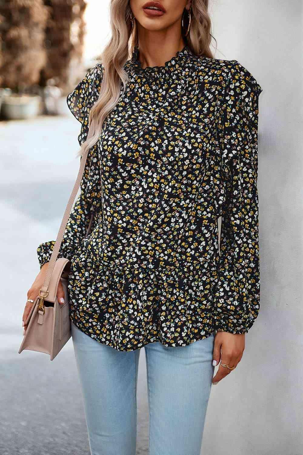 a woman wearing a black and yellow floral blouse