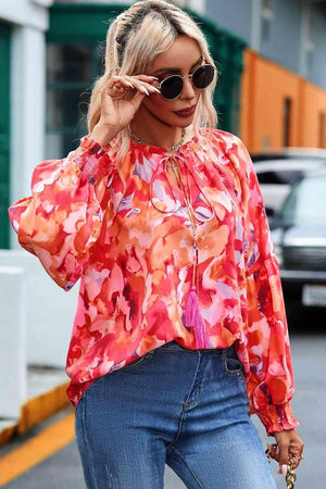 a woman in jeans and a blouse is walking down the street