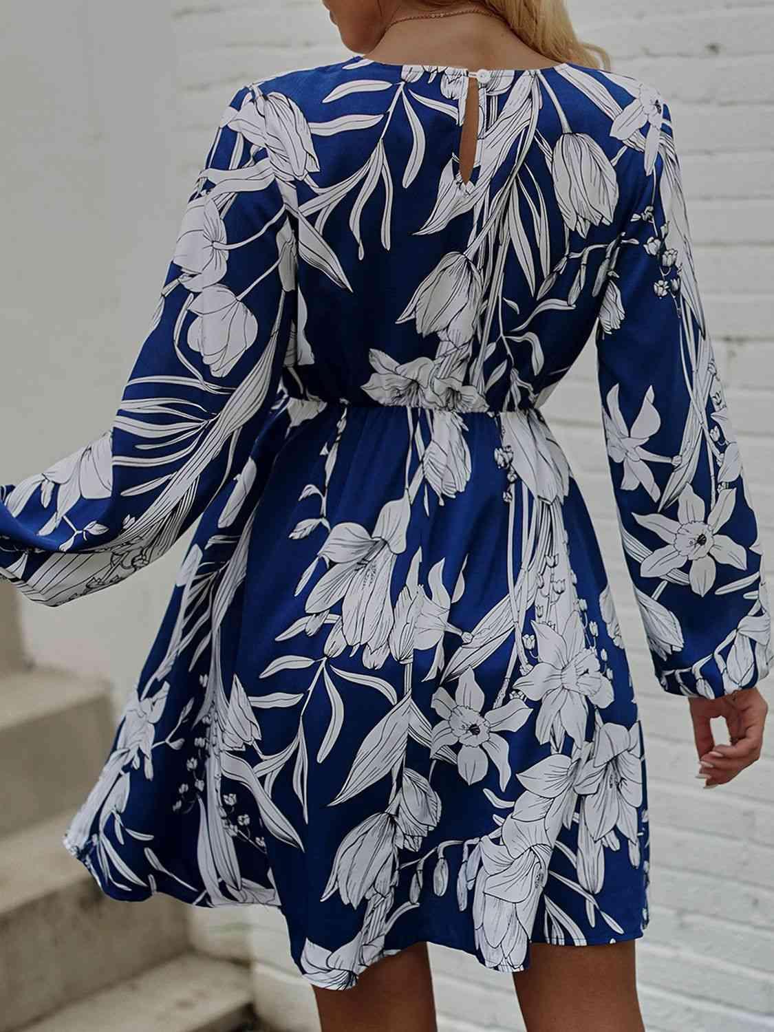 a woman wearing a blue and white floral print dress