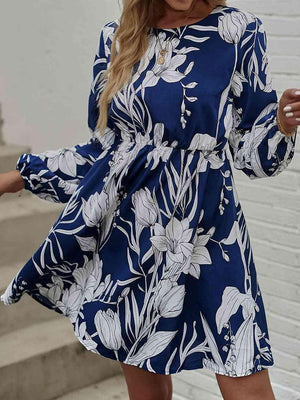 a woman wearing a blue and white floral print dress