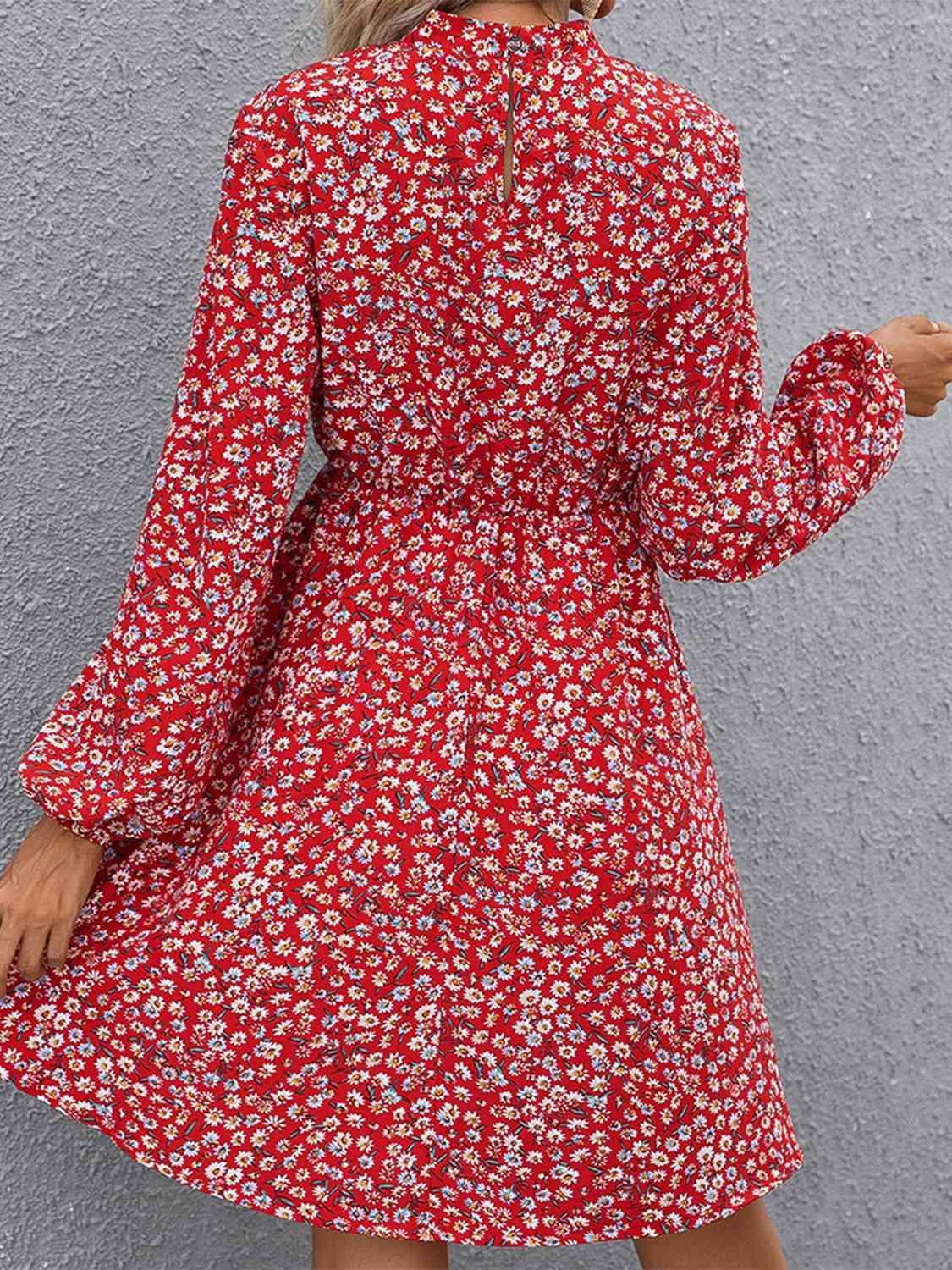 a woman in a red floral print dress