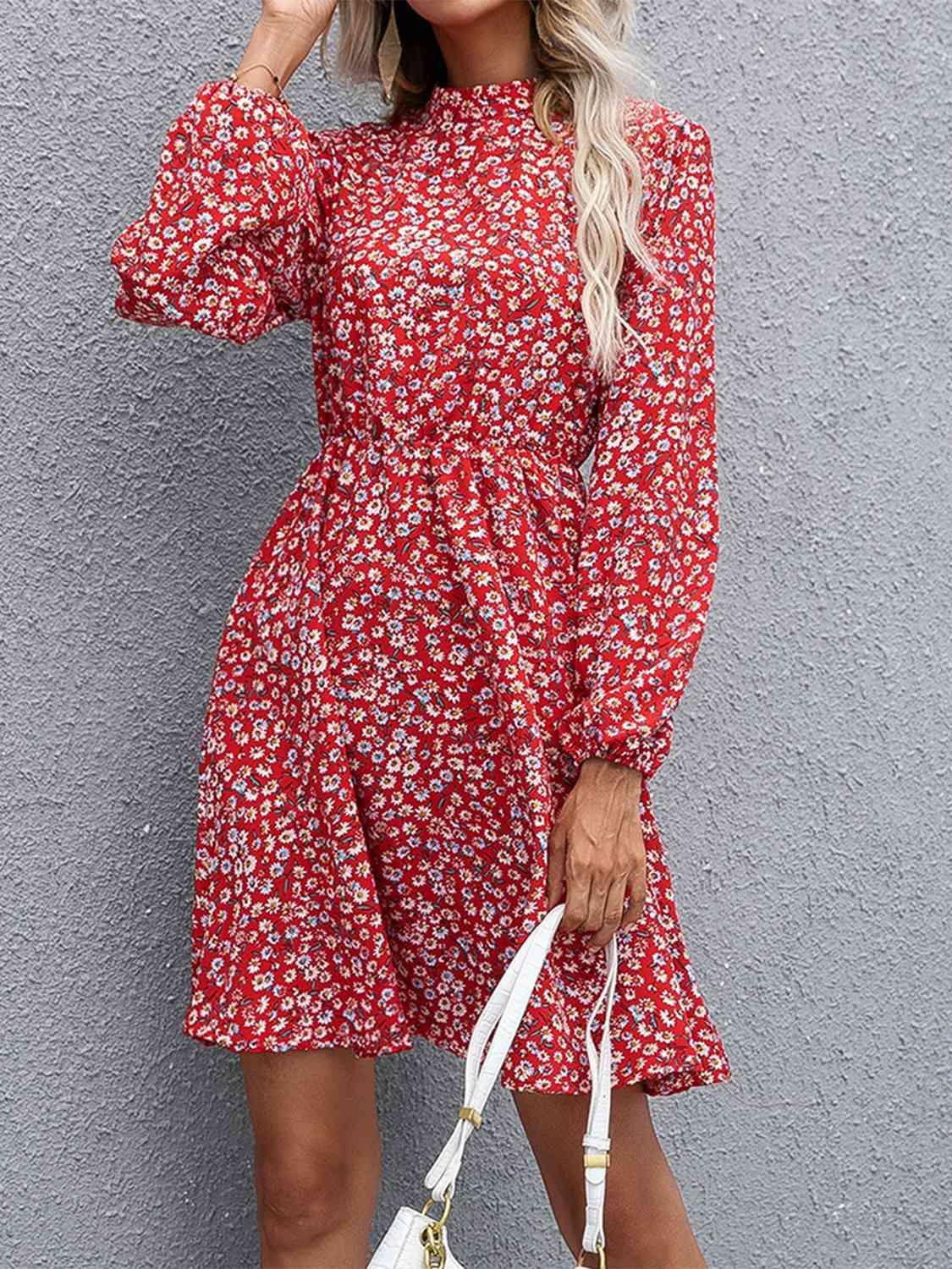 a woman in a red floral dress holding a white handbag