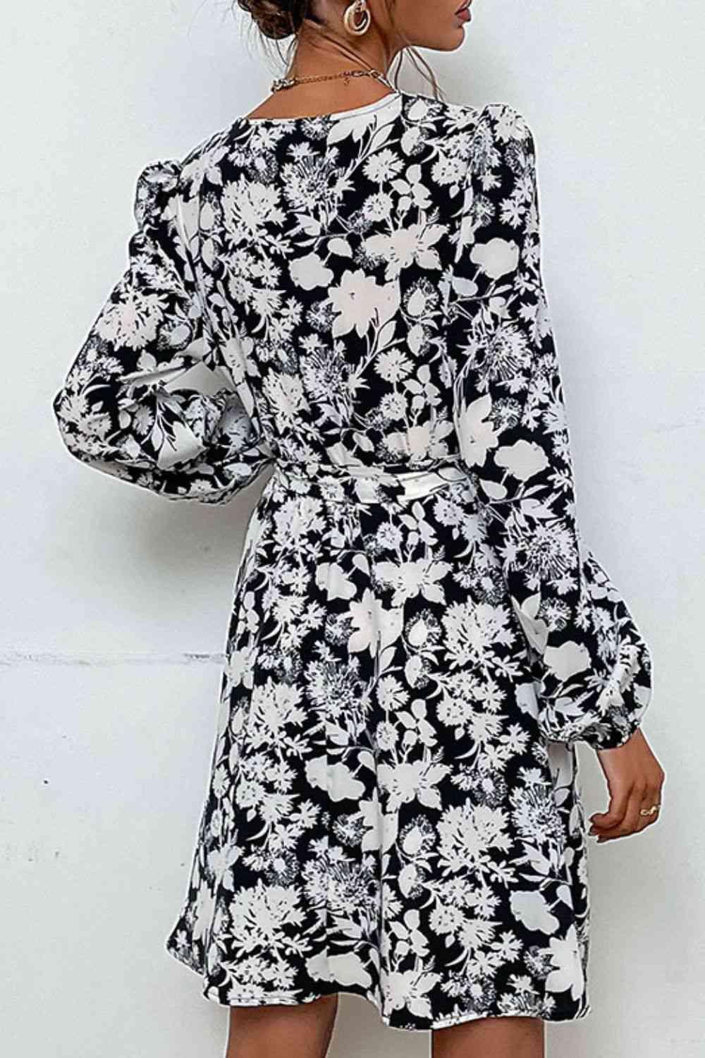 a woman wearing a black and white floral print dress