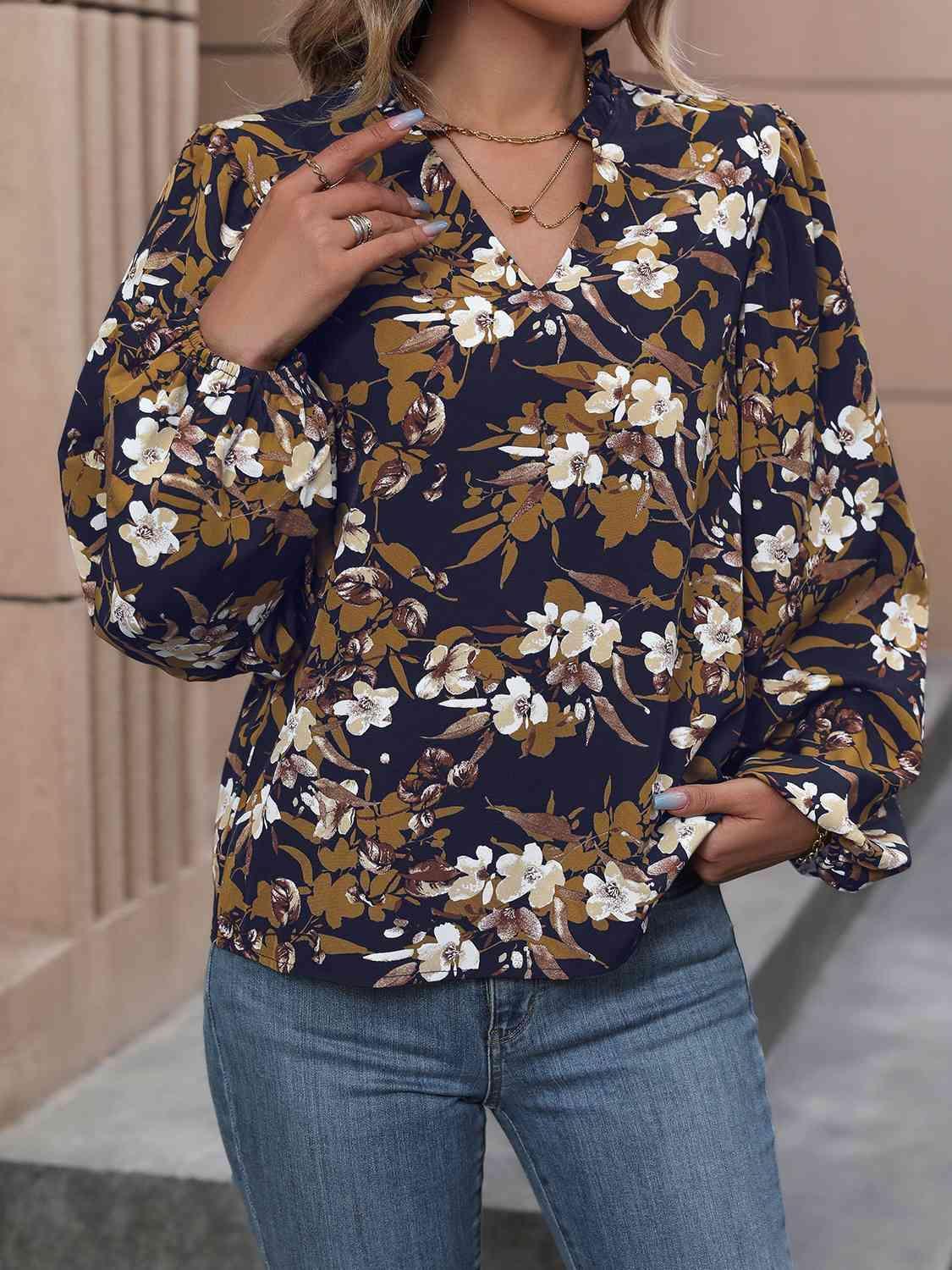 a woman wearing a floral blouse and jeans