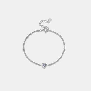 a silver bracelet with a heart charm