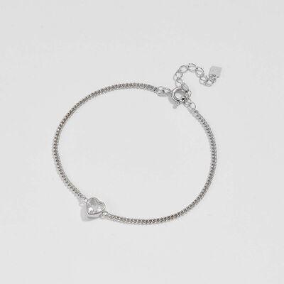 a silver bracelet with a heart charm