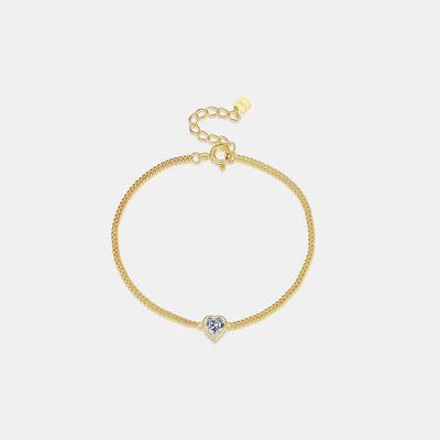 a gold bracelet with a heart charm