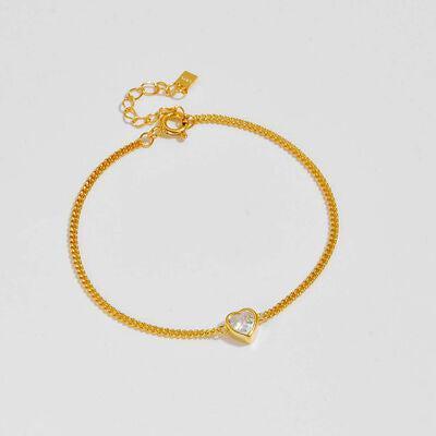 a gold bracelet with a heart charm