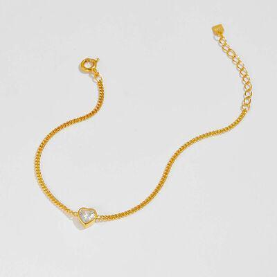 a gold chain bracelet with a heart charm