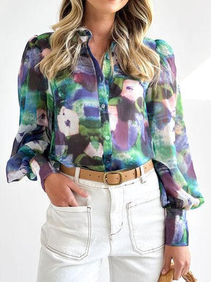 a woman wearing a colorful shirt and white pants