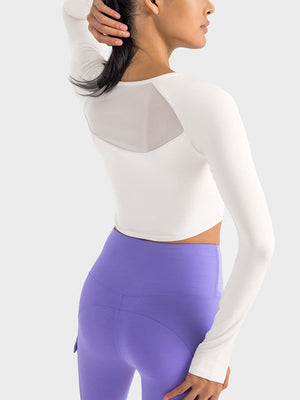 a woman in a white top and purple leggings